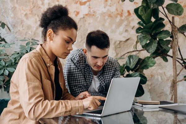 two people sat at a laptop