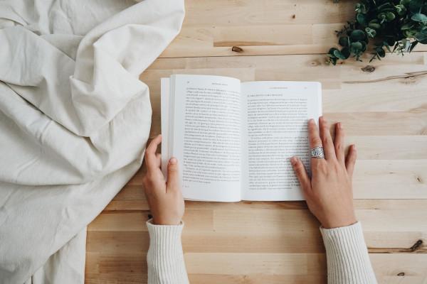 persons hands holding an open book